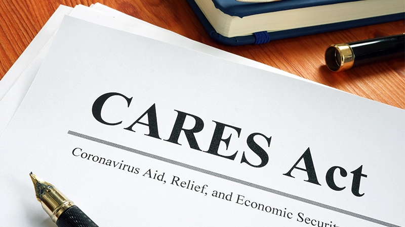 Coronavirus Aid, Relief, and Economic Security CARES Act on the desk.
