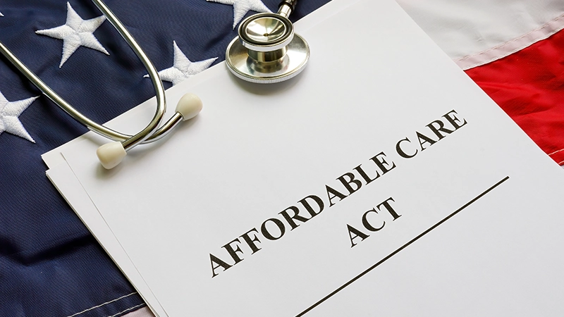 Affordable Care Act ACA, flag and a stethoscope.