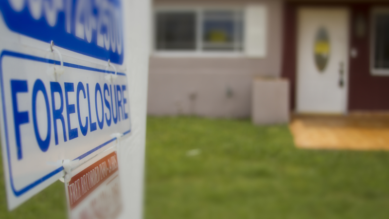 A foreclosure sign outside of a condemned home.